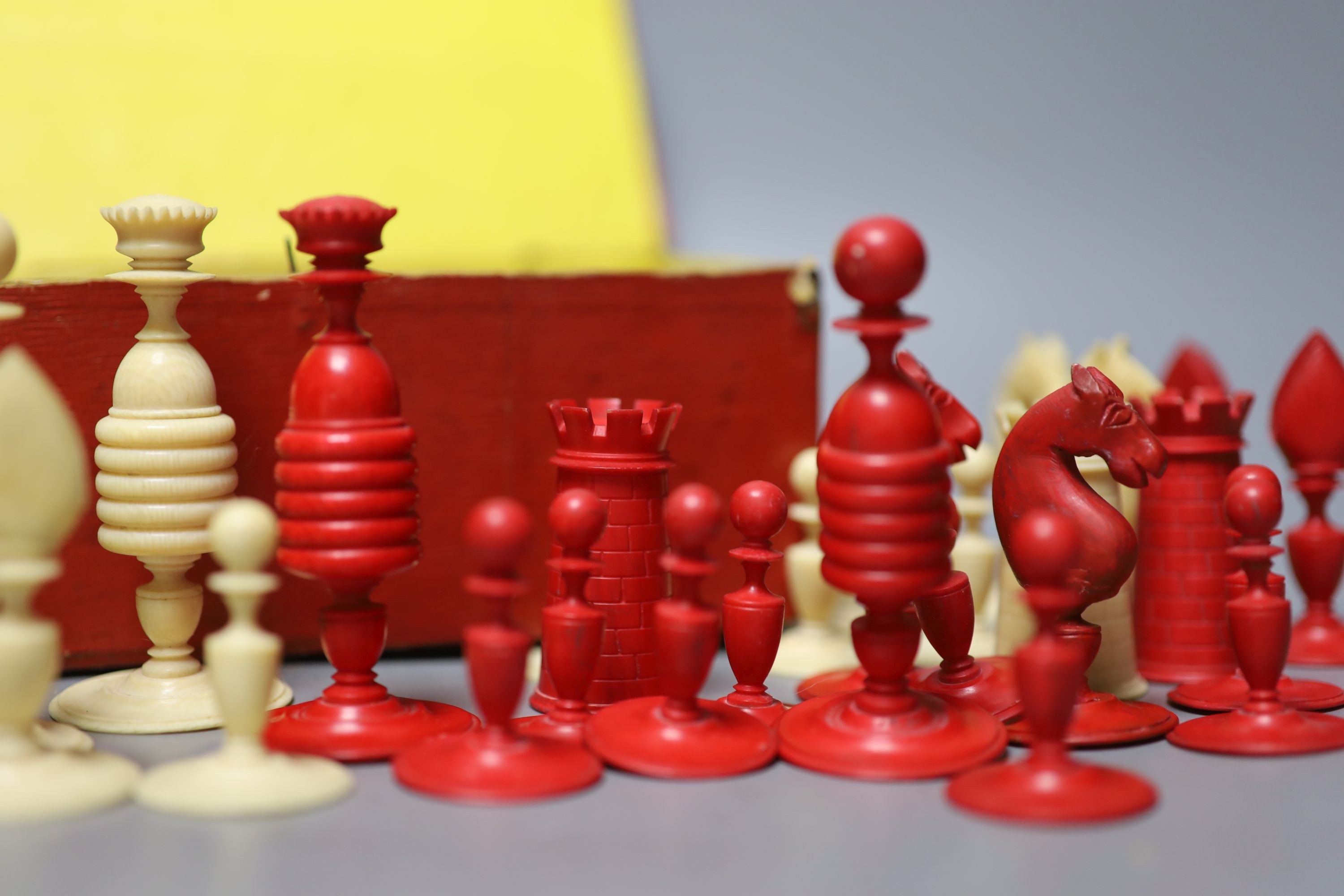 A 19th century red stained and natural ivory chess set, Kings 8.2 cm